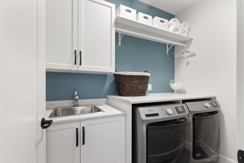 a small kitchen with a sink and a dishwasher at 165 - 2450 Radio Tower Rd-Jacobson in Osoyoos
