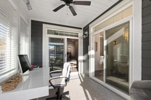 a home office with a desk and a ceiling fan at 165 - 2450 Radio Tower Rd-Jacobson in Osoyoos