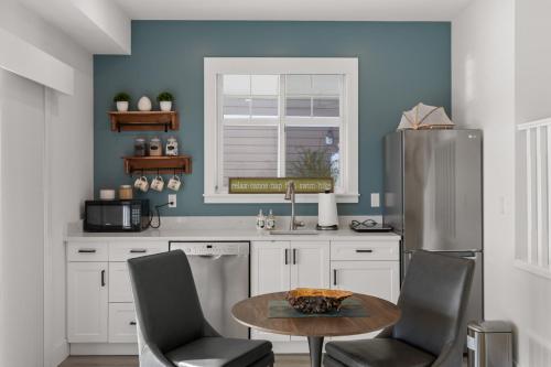 a kitchen with a table and chairs and a refrigerator at 165 - 2450 Radio Tower Rd-Jacobson in Osoyoos