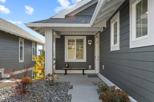 a house with a bench on the front porch at 165 - 2450 Radio Tower Rd-Jacobson in Osoyoos