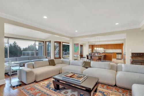 a large living room with a couch and a table at The West Vancouver Getaway Estate 5 Bedrooms in West Vancouver