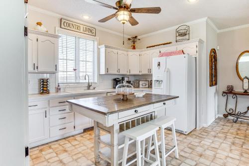 a kitchen with white cabinets and a white refrigerator at Fire Pit and Gazebo Rural Warrensburg Getaway! in Warrensburg