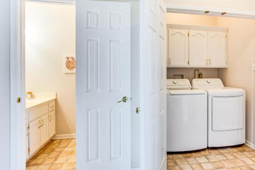a white laundry room with a washer and dryer at Fire Pit and Gazebo Rural Warrensburg Getaway! in Warrensburg