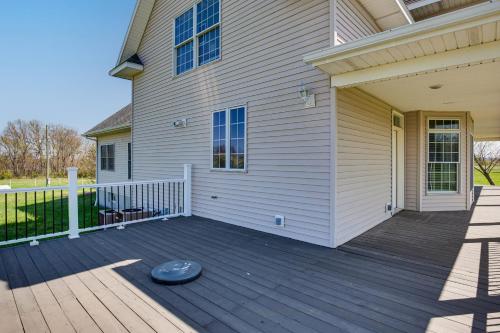 a front porch of a house with a wooden deck at Fire Pit and Gazebo Rural Warrensburg Getaway! in Warrensburg