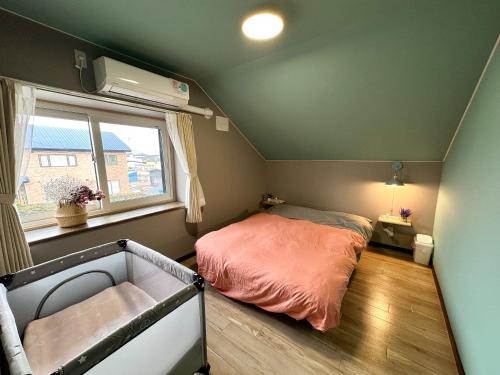 a small bedroom with a bed and a window at MATSUNE 松寧 6min walk to Noboribetsu st in Noboribetsu