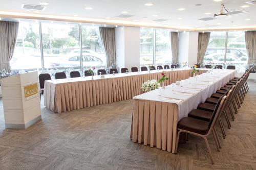 a row of tables in a room with chairs at Blanca Hotel in Izmir