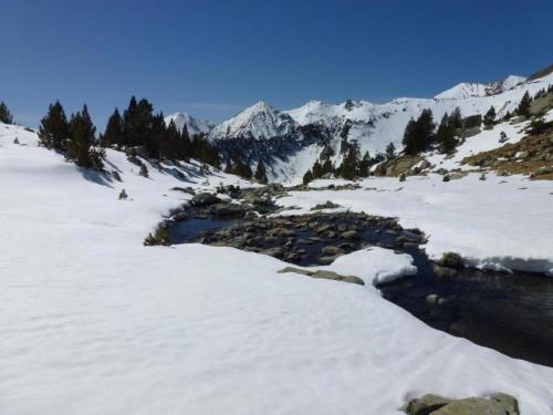 a river in the snow with mountains in the background at Tranquil Aragonese Retreat in La Puebla de Roda