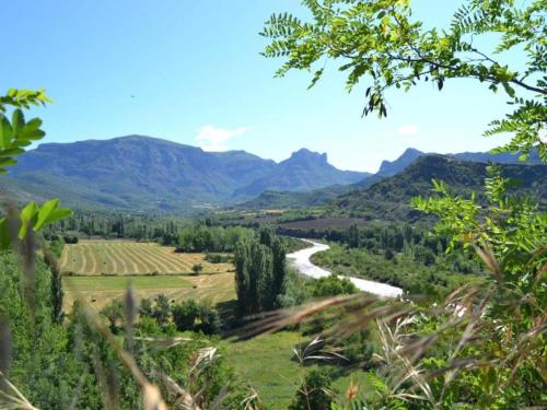 a valley with a river and mountains in the background at Tranquil Aragonese Retreat in La Puebla de Roda