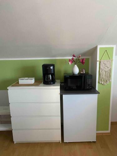 a kitchen with a microwave and a coffee maker on a counter at Ferienwohnung Alpenblick in Wasserburg am Inn