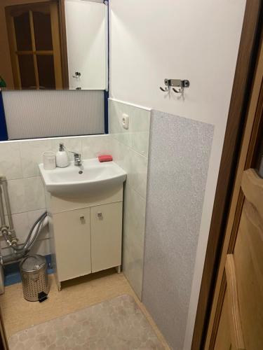 a bathroom with a sink and a mirror at Arkuszowa 58 Apartament 5 in Warszawa