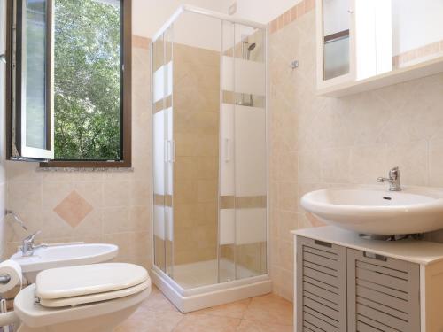 a bathroom with a sink and a toilet and a shower at B&B I Colori di Chia in Chia