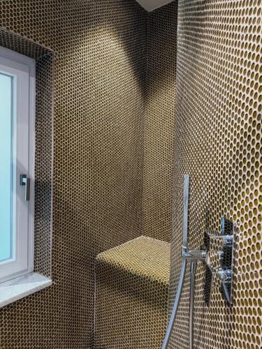 a bathroom with a shower with a bench in it at PRIVATE LUXURY FONTANA DI TREVI in Rome
