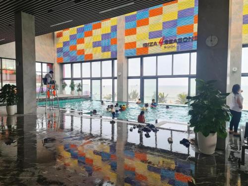 a pool with ducks in it with people in the water at Flamingo Hai Tien in Hoằng Hóa