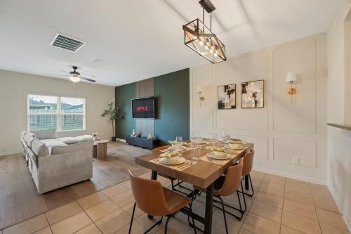 a dining room with a table and chairs and a couch at IAH 6 Miles Spacious 5 Bedroom Home with 3 King Beds in Humble