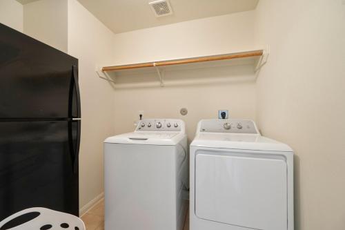 a kitchen with a refrigerator and two washing machines at IAH 6 Miles Spacious 5 Bedroom Home with 3 King Beds in Humble
