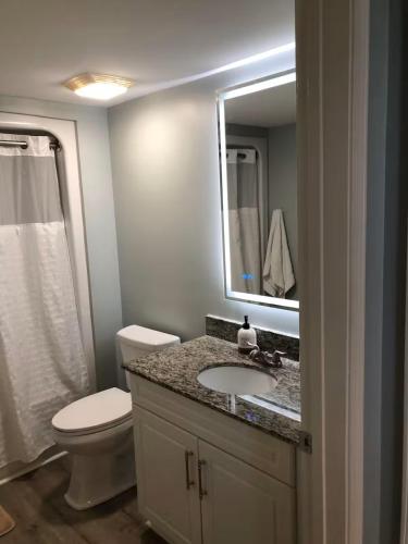 a bathroom with a toilet and a sink and a mirror at Luxury 2br 2 ba beachfront condo in Myrtle Beach