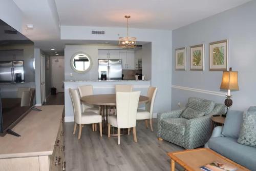 a kitchen and living room with a table and chairs at Luxury 2br 2 ba beachfront condo in Myrtle Beach