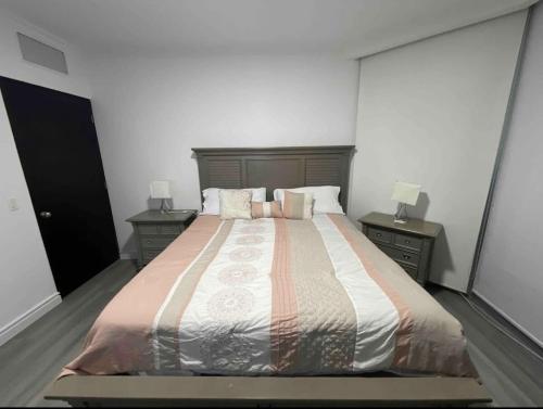 a bedroom with a large bed with two night stands at Apartment in Panama City in Panama City