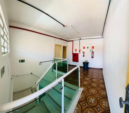 an empty room with a staircase in a building at Colonia SINTIPACESP in Praia Grande