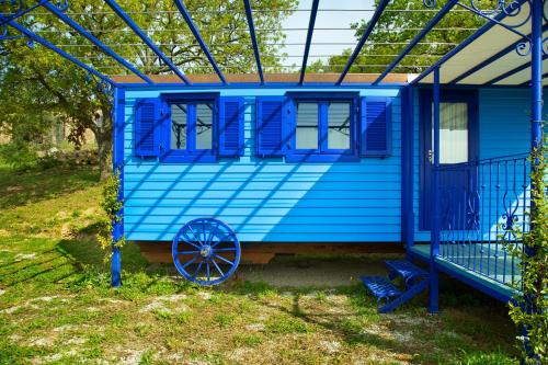 a blue tiny house with a blue roof at Poggio Diavolino - Suvereto in Suvereto
