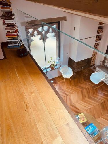 a living room with a glass staircase and a wooden floor at La Limonaia della Torretta Luxury Private Pool in Florence