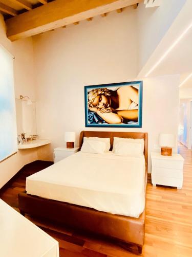 a bedroom with a bed and a painting on the wall at La Limonaia della Torretta Luxury Private Pool in Florence