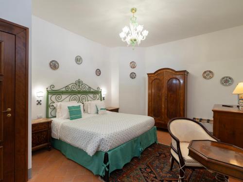 a bedroom with a bed and a table and a chair at Borgia di Firenze in Florence