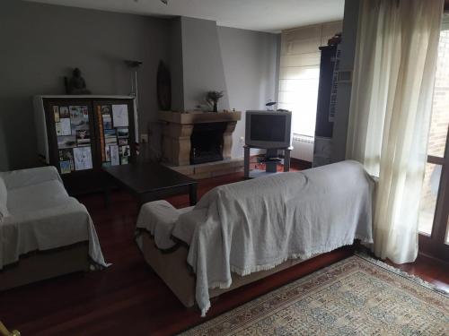 a living room with a couch and a tv at Chalet in Miengo with a community pool in Miengo
