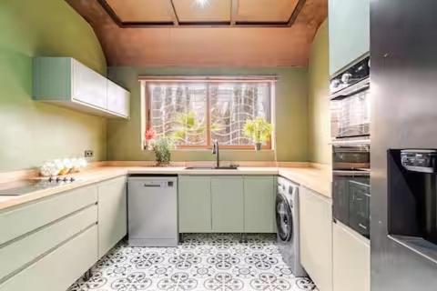 a kitchen with a sink and a dishwasher at villa a marrakech with warm pool in Marrakech