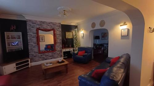 a living room with a couch and chairs and a mirror at Large countryside home in Tow Law