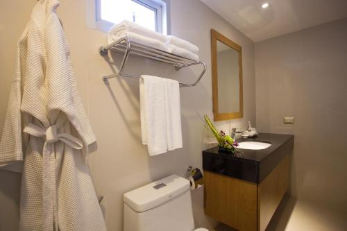 a bathroom with a toilet and a sink and a mirror at Chabana Kamala Hotel in Kamala Beach