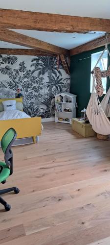 a bedroom with a bed and a hammock at Maison familiale Ecole des Filles in Ully-Saint-Georges