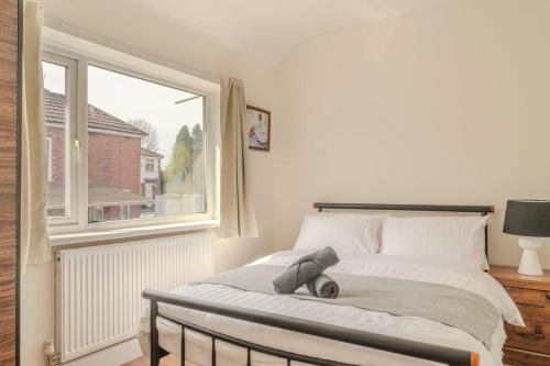 a bedroom with a bed and a large window at Cozy House in Manchester