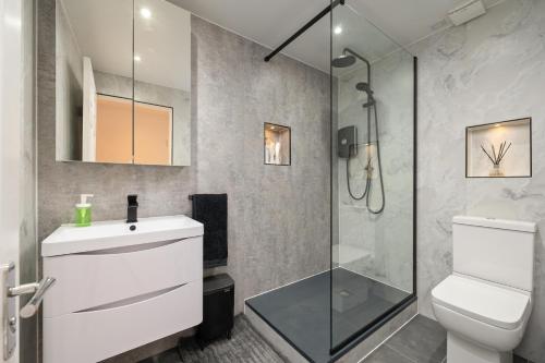 a bathroom with a shower and a toilet and a sink at Heart of Edinburgh's Historic Old Town - Blair Street - Sleeps 6 in Edinburgh