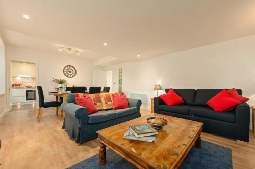 a living room with two couches and a table at Heart of Edinburgh's Historic Old Town - Blair Street - Sleeps 6 in Edinburgh