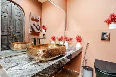 a bathroom with two sinks and a large tub at villa a marrakech with warm pool in Marrakech