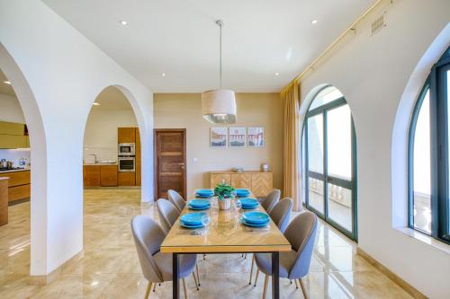 a dining room with a table and chairs at Spacious, Bright, Valley & Sea View Maisonette in Xagħra