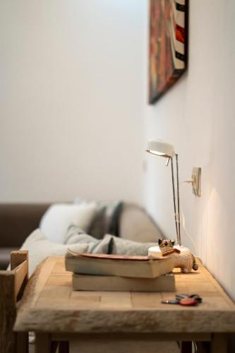 a table with a lamp and a book on it at Chic & Cozy Retreat in Agadir in Agadir