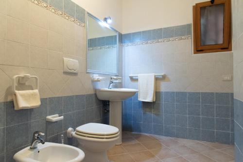 a bathroom with a toilet and a sink at Soraya - Suites & Apartments in Palau