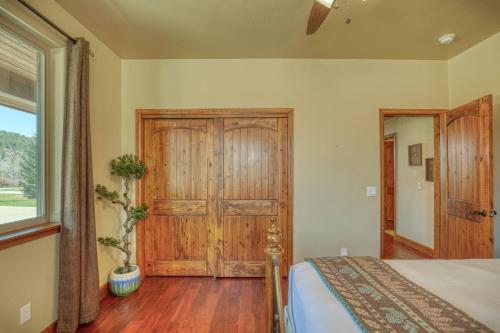 a bedroom with a bed and a wooden door at 10 Cobblestone Ln in Pagosa Springs