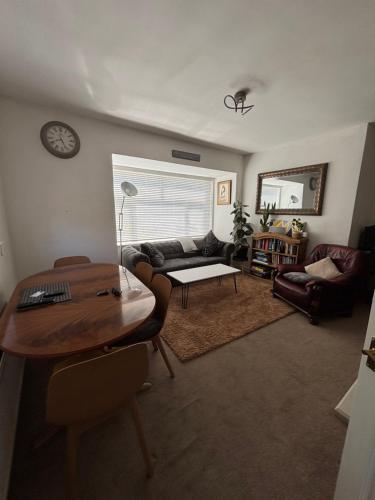 a living room with a couch and a table at Spacious comfy flat near Airport and Altrincham in Wythenshawe