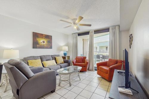 a living room with a couch and chairs and a tv at Harbour Place 506 in Gulf Shores
