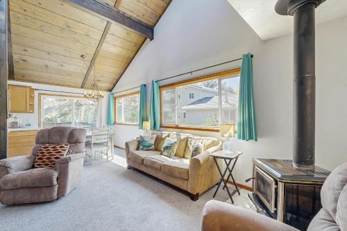 a living room with a couch and chairs and a stove at Rockaway Beach Surfer's Paradise in Rockaway Beach