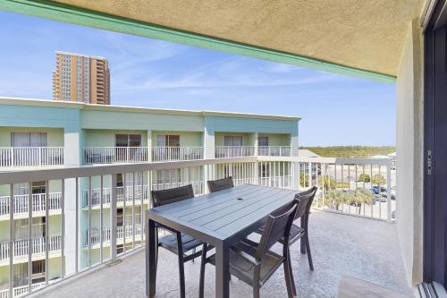 a patio with a table and chairs on a balcony at Harbour Place 506 in Gulf Shores