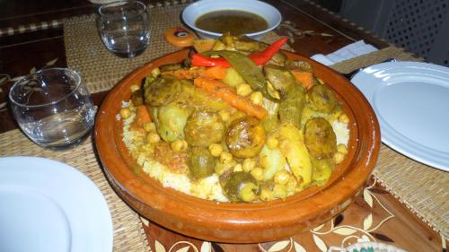 a bowl of food with beans and vegetables on a table at Riad Marco Andaluz in Sale