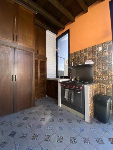 a kitchen with a stove and a window in it at Castillo De La Santa Cruz in Guanajuato