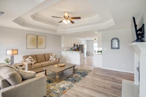 a living room with a couch and a ceiling fan at Patio and Spacious Yard Home in Athens in Harvest