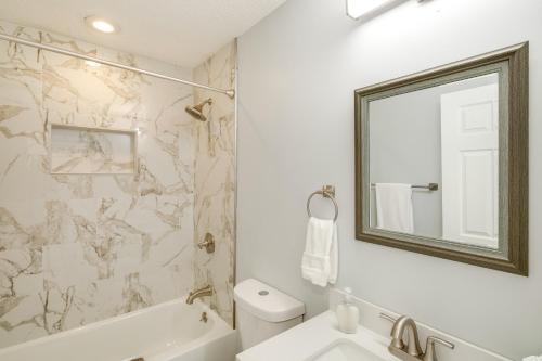 a bathroom with a tub and a sink and a mirror at Patio and Spacious Yard Home in Athens in Harvest