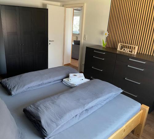 a bedroom with two beds and a dresser at Ferienwohnung Sonnenblick in Sonneberg