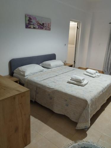 a bedroom with two beds with towels on them at Dim's villas in Qeparo